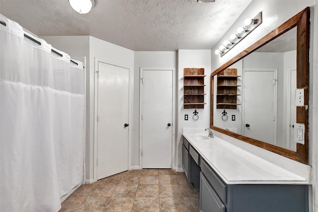 bathroom with a textured ceiling and vanity