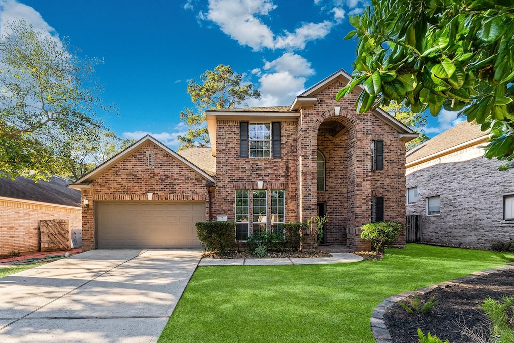 view of front property with a garage and a front yard