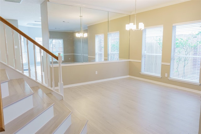 interior space featuring ornamental molding, a chandelier, and plenty of natural light