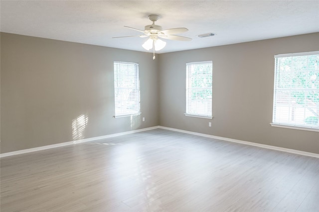 spare room with ceiling fan and light hardwood / wood-style floors