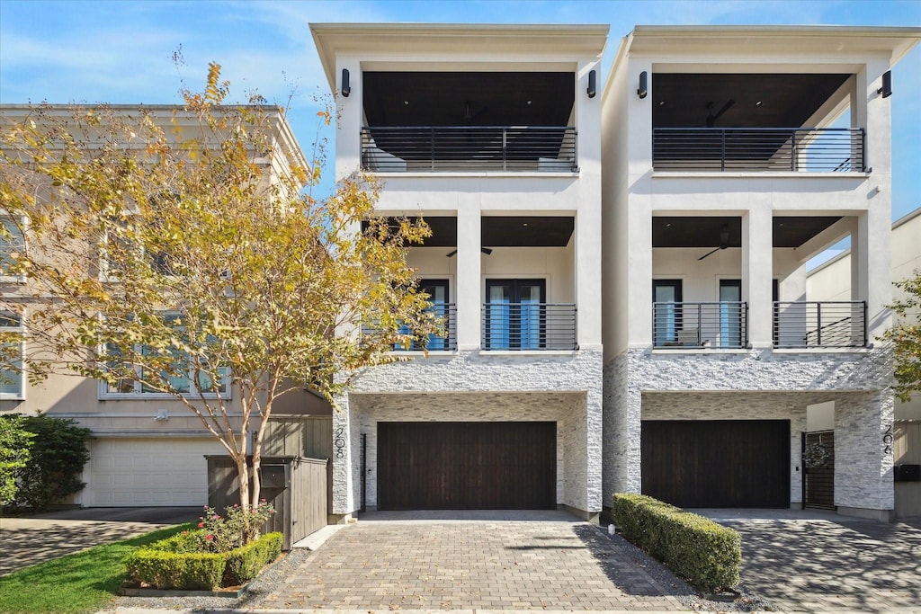 modern home featuring a garage and a balcony