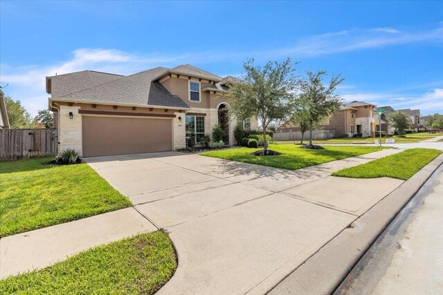 view of front of home with a garage and a front lawn