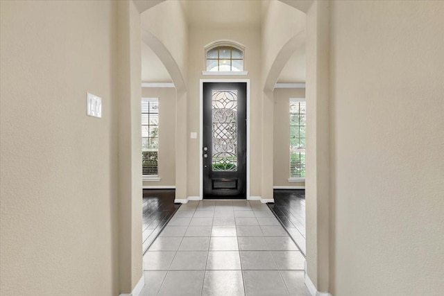 foyer entrance featuring a high ceiling and light tile patterned flooring