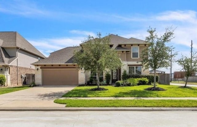 view of front of property with a front lawn and a garage