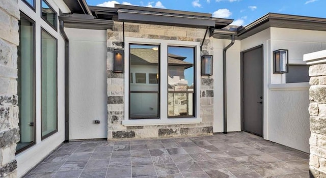 doorway to property with a patio area