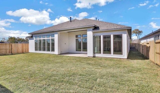 rear view of house featuring a yard and a patio