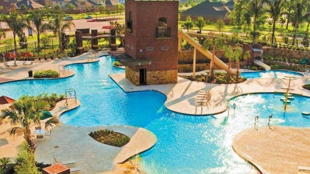 view of pool featuring a patio area and a water slide