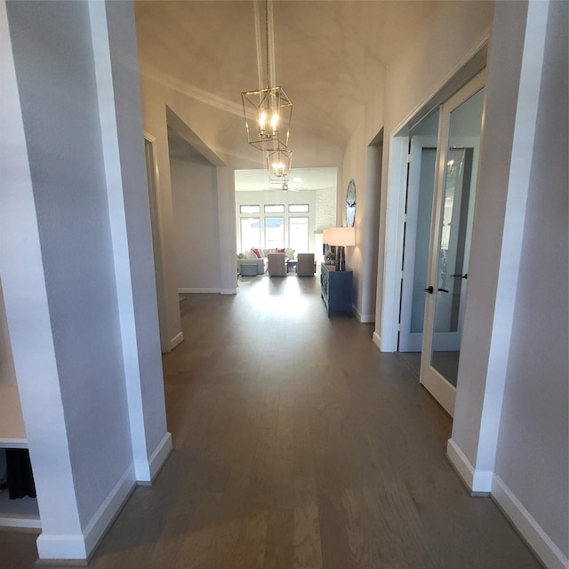 hall featuring a chandelier and hardwood / wood-style floors