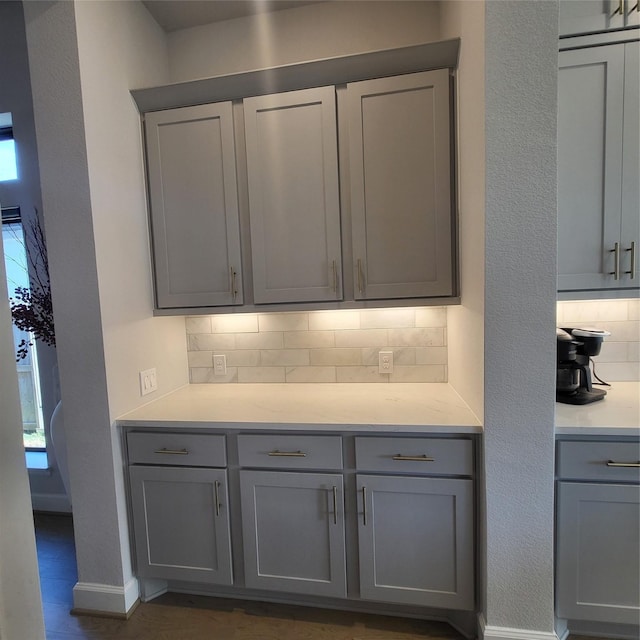 kitchen featuring backsplash and gray cabinets