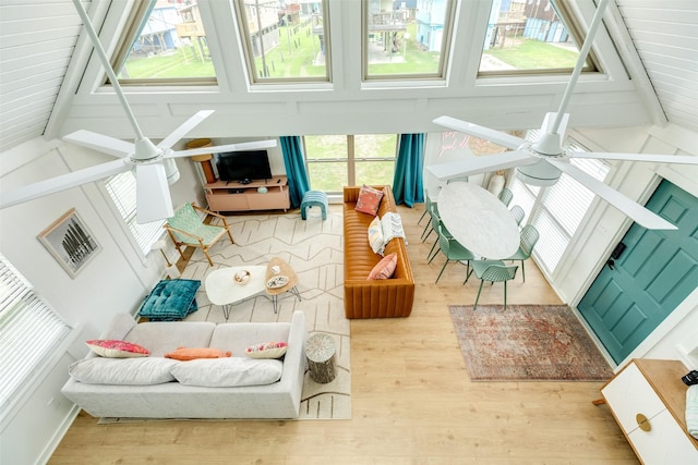 sunroom / solarium featuring vaulted ceiling with beams and a ceiling fan