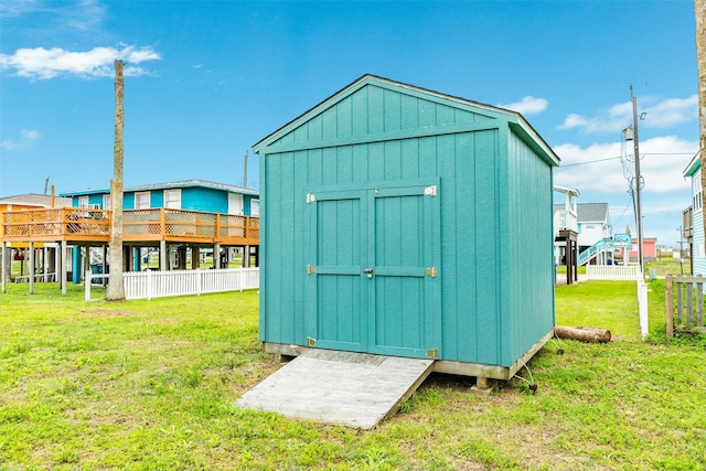 view of shed featuring fence