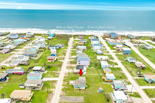 drone / aerial view featuring a residential view and a water view