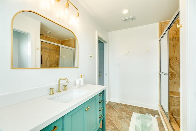 bathroom with visible vents, a stall shower, vanity, and baseboards