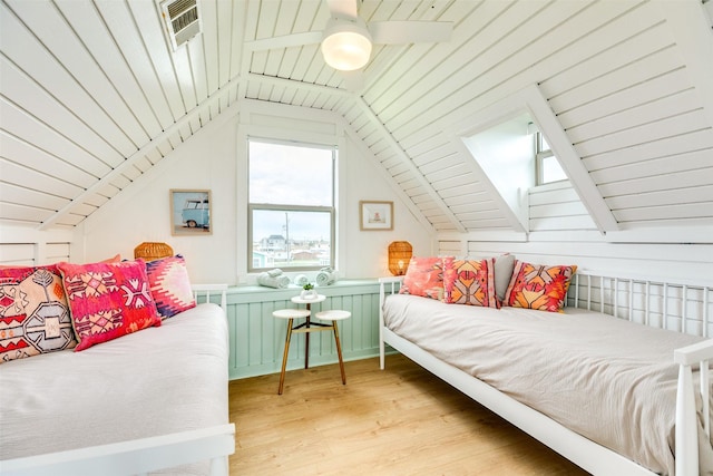 bedroom featuring visible vents, lofted ceiling, and light wood-style flooring