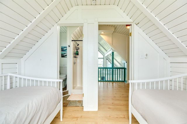 bedroom featuring wood ceiling, light wood-style floors, and vaulted ceiling