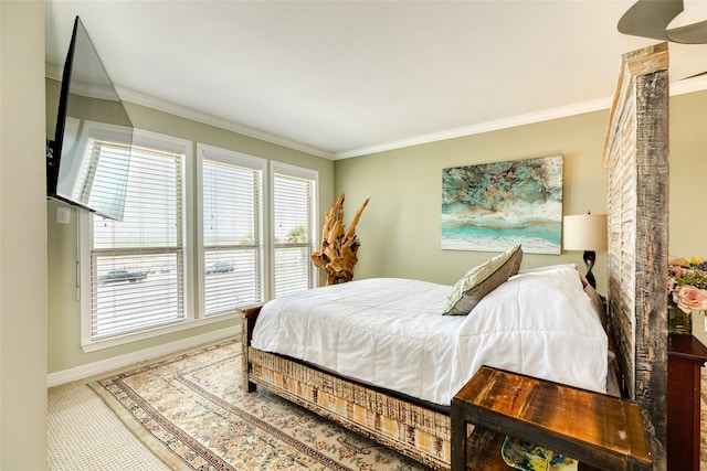 bedroom featuring crown molding and carpet