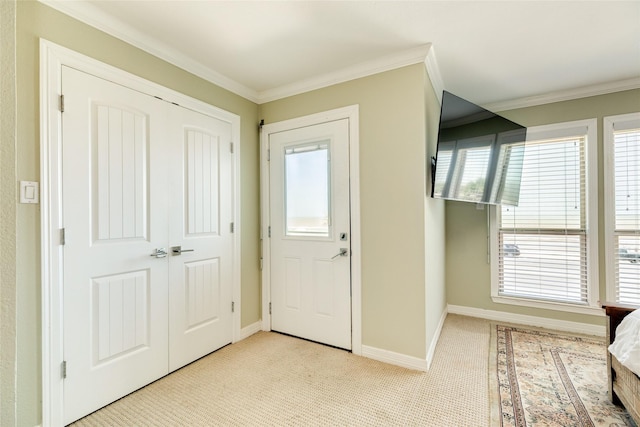 foyer featuring crown molding and a wealth of natural light