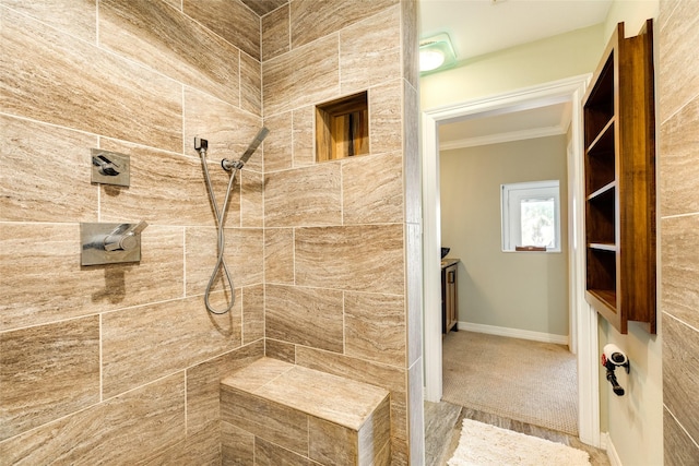 bathroom featuring a tile shower and crown molding