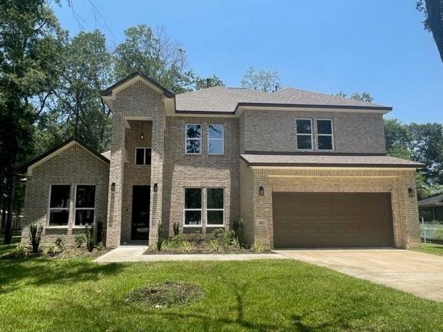 view of front of home with a front lawn and a garage