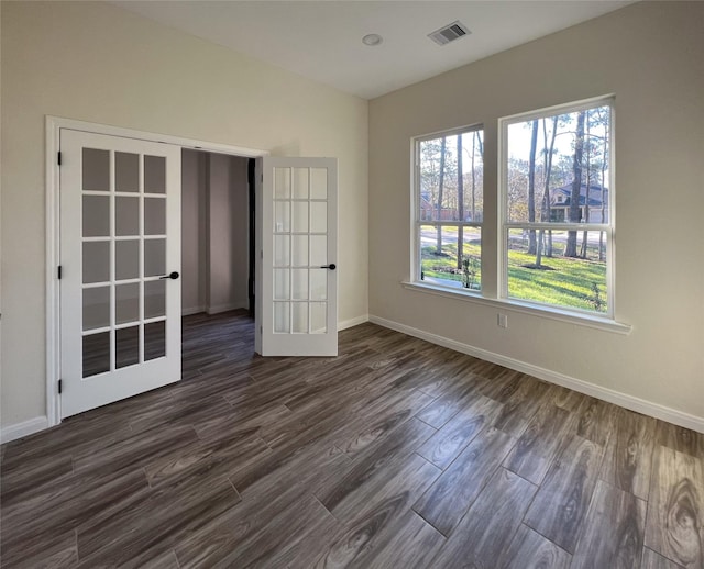 empty room with french doors and dark hardwood / wood-style floors