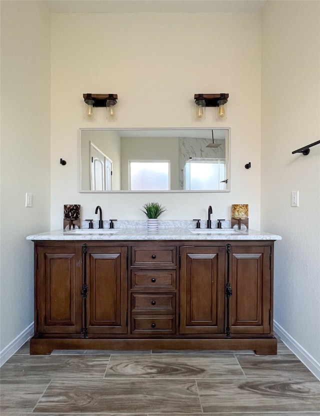 bathroom featuring a shower and vanity