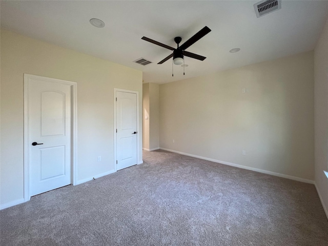 unfurnished bedroom featuring ceiling fan and carpet