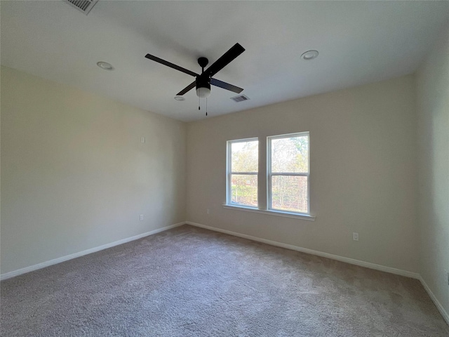 carpeted spare room with ceiling fan