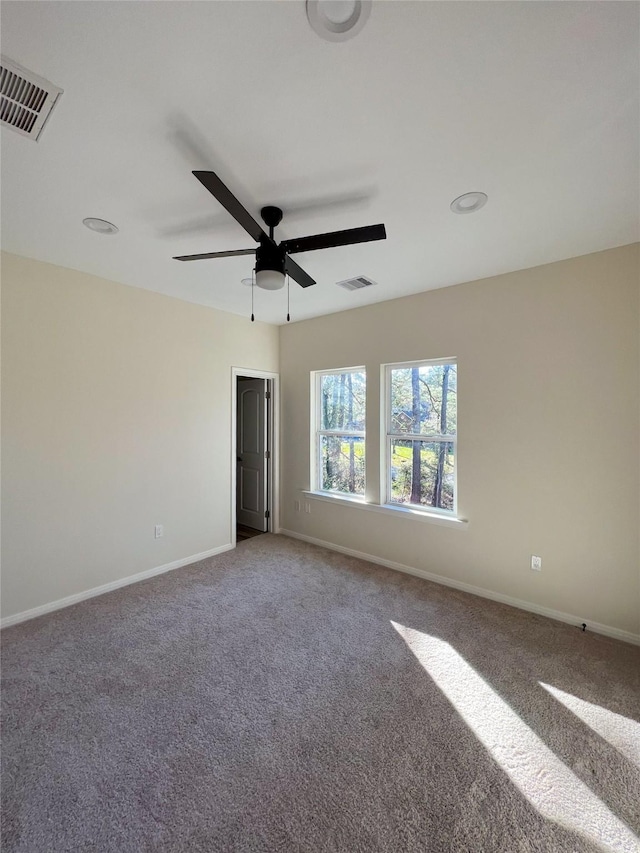 carpeted empty room featuring ceiling fan