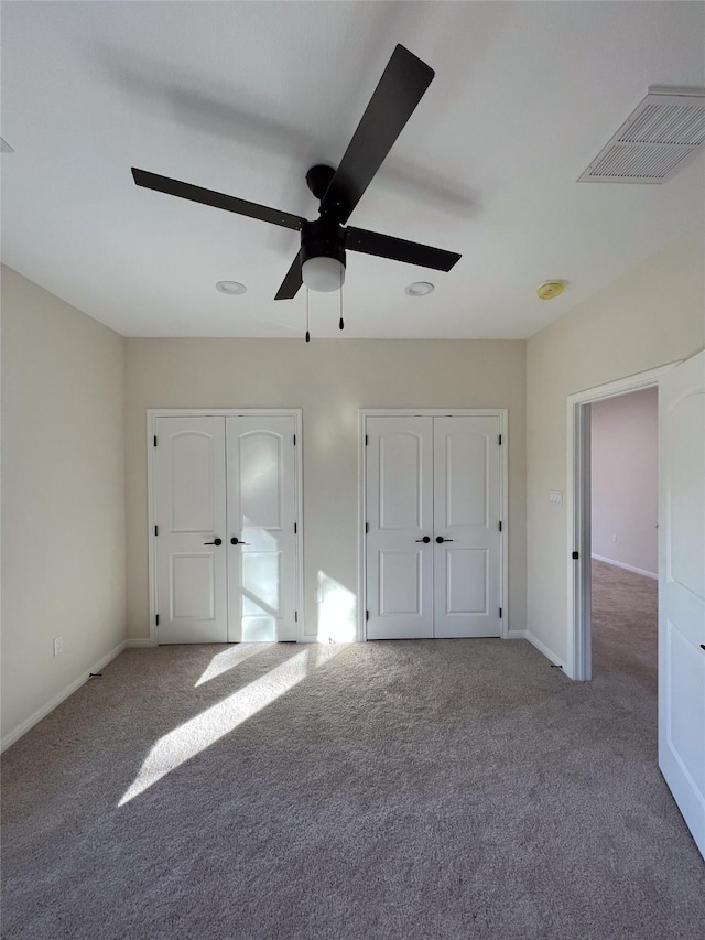 unfurnished bedroom featuring ceiling fan and carpet