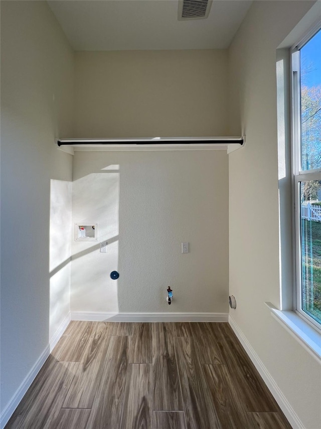 laundry area featuring washer hookup, gas dryer hookup, plenty of natural light, and hardwood / wood-style flooring