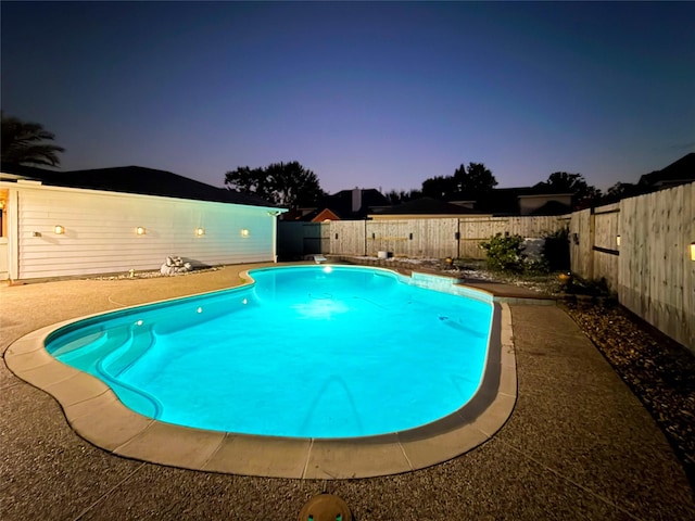 view of pool at dusk