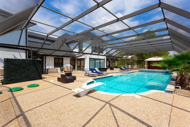 view of swimming pool featuring a diving board, glass enclosure, and a patio