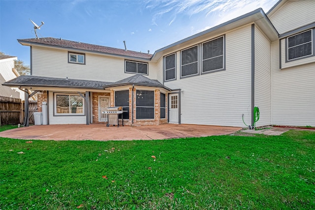 back of property featuring a patio and a yard