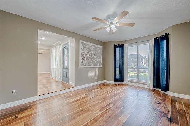 spare room featuring a textured ceiling, hardwood / wood-style floors, and ceiling fan