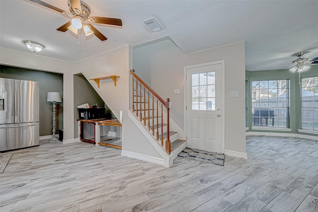 entrance foyer featuring ceiling fan