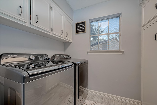 laundry room with cabinets and washer and clothes dryer