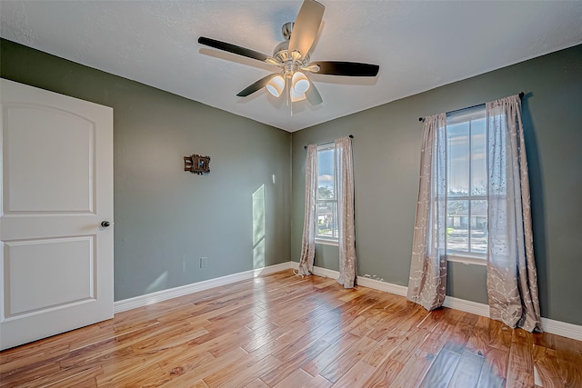 spare room with ceiling fan and light hardwood / wood-style floors