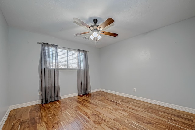 unfurnished room with ceiling fan and light hardwood / wood-style flooring