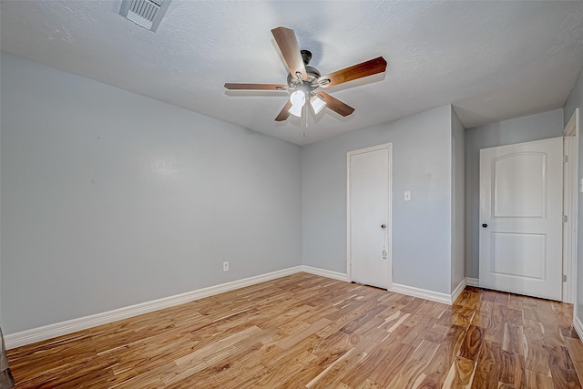 unfurnished room with a textured ceiling, ceiling fan, and light hardwood / wood-style floors