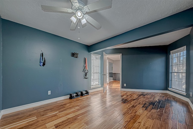 unfurnished room with hardwood / wood-style flooring, a textured ceiling, and ceiling fan