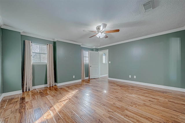 unfurnished room with ceiling fan, light wood-type flooring, and ornamental molding