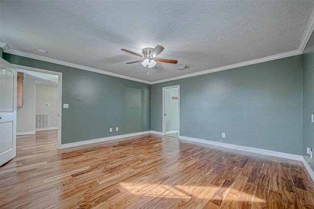 empty room with ceiling fan, light wood-type flooring, ornamental molding, and a textured ceiling