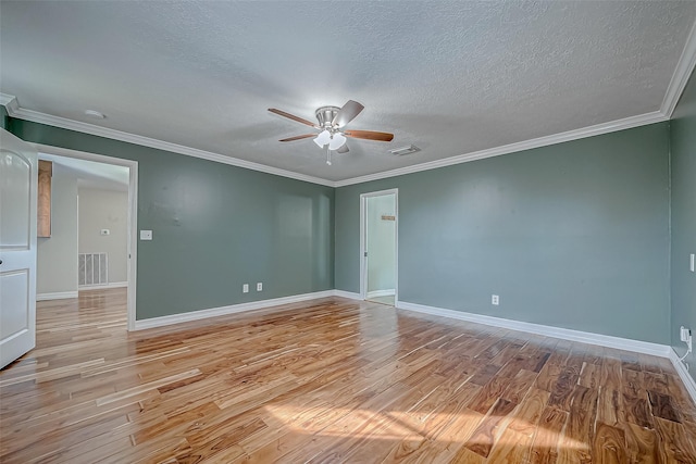 spare room featuring ceiling fan, crown molding, a textured ceiling, and light hardwood / wood-style floors