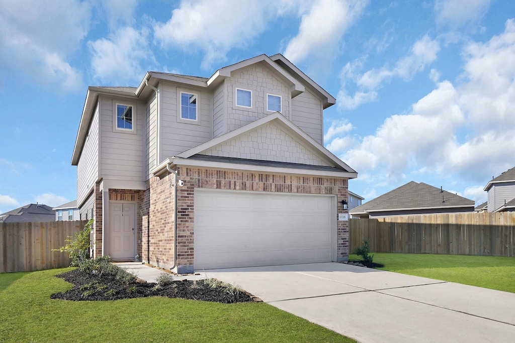 craftsman-style house featuring a front yard and a garage