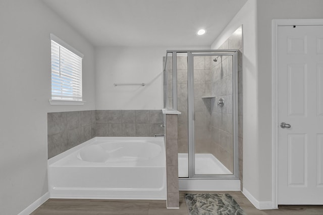 bathroom with separate shower and tub