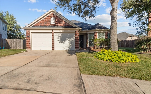 view of front of house with a front yard and a garage