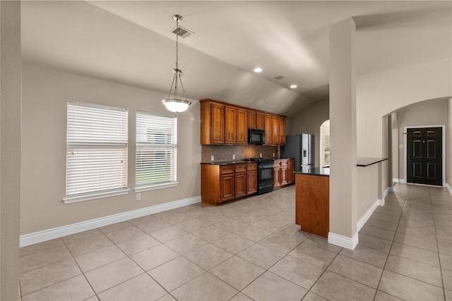 kitchen featuring black appliances, light tile patterned floors, decorative light fixtures, lofted ceiling, and tasteful backsplash