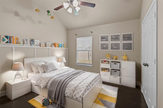 bedroom with dark hardwood / wood-style flooring, a closet, ceiling fan, and vaulted ceiling