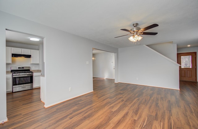 unfurnished living room featuring ceiling fan and dark wood-type flooring