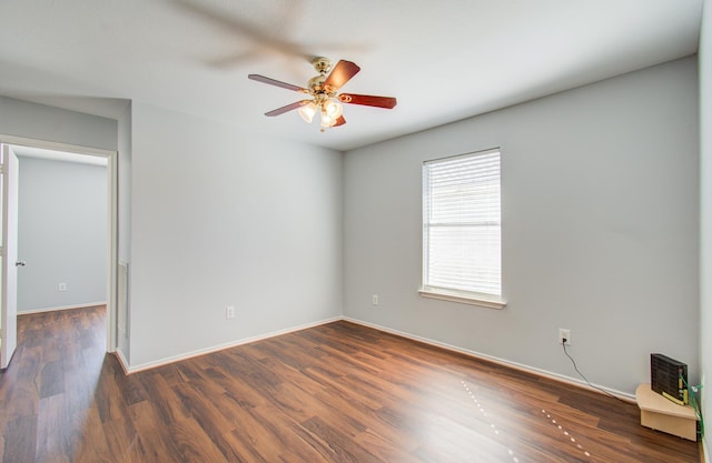 empty room featuring ceiling fan and dark hardwood / wood-style floors